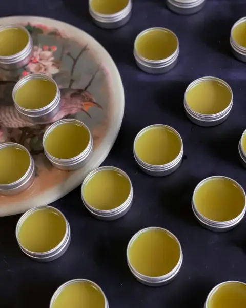 Small open tins arranged on a dark tray